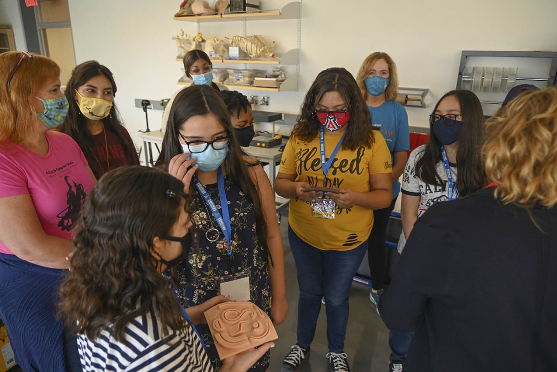 ACES campers take a look at simulated skin made in the ASTEC tissue lab. The skin is used by Health Science students to practice suturing.