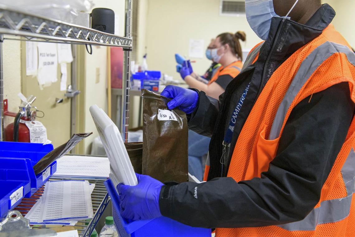 UArizona Campus Health Pharmacy Technician Pearl Craig (right) gathers vaccines that are ready to be distributed to people at the scheduled walk-in location at the Ina E. Gittings Building.