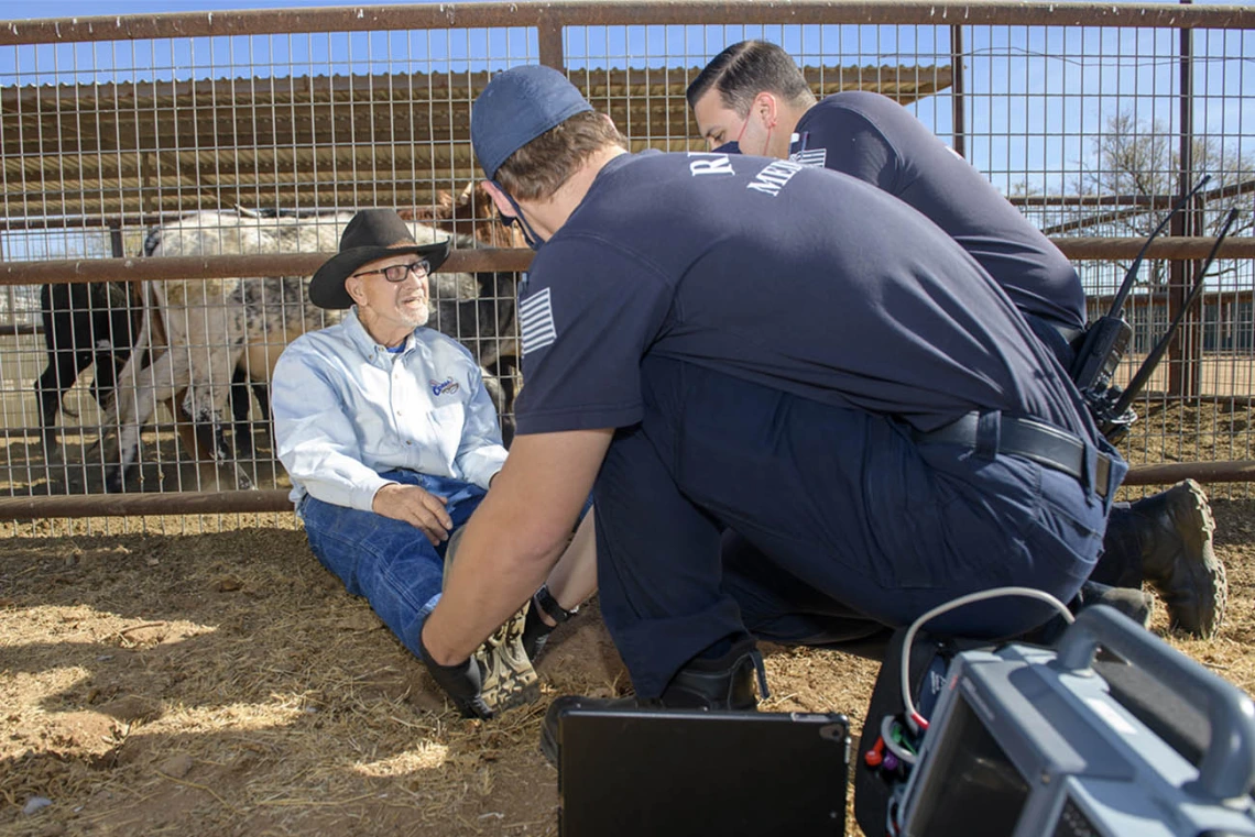 Weber and Saenz talk to the patient to prepare him for examination. (Note: This was a simulated accident scene for demonstration purposes.)