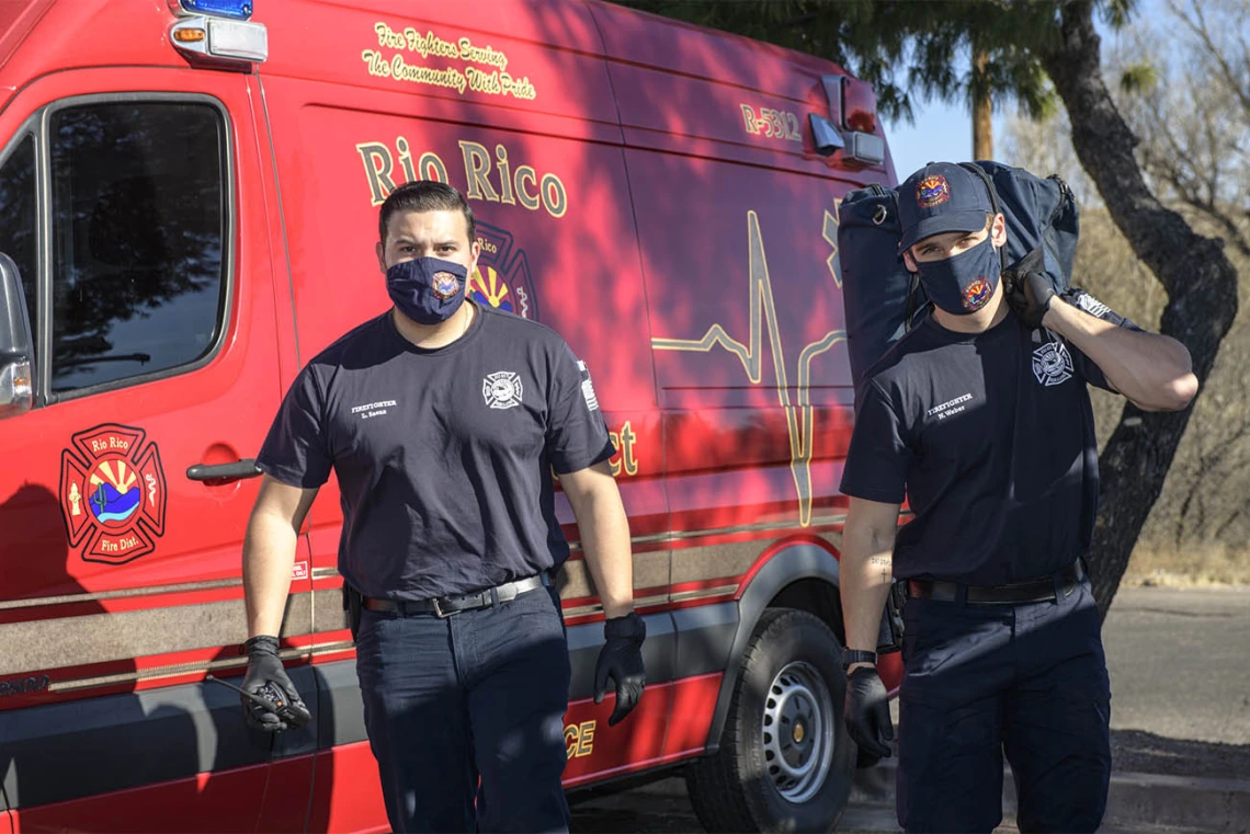 Rio Rico emergency medical technicians Luis Saenz and Nick Weber approach an accident scene to tend to a patient with an ankle injury. (Note: This was a simulated accident scene for demonstration purposes.)