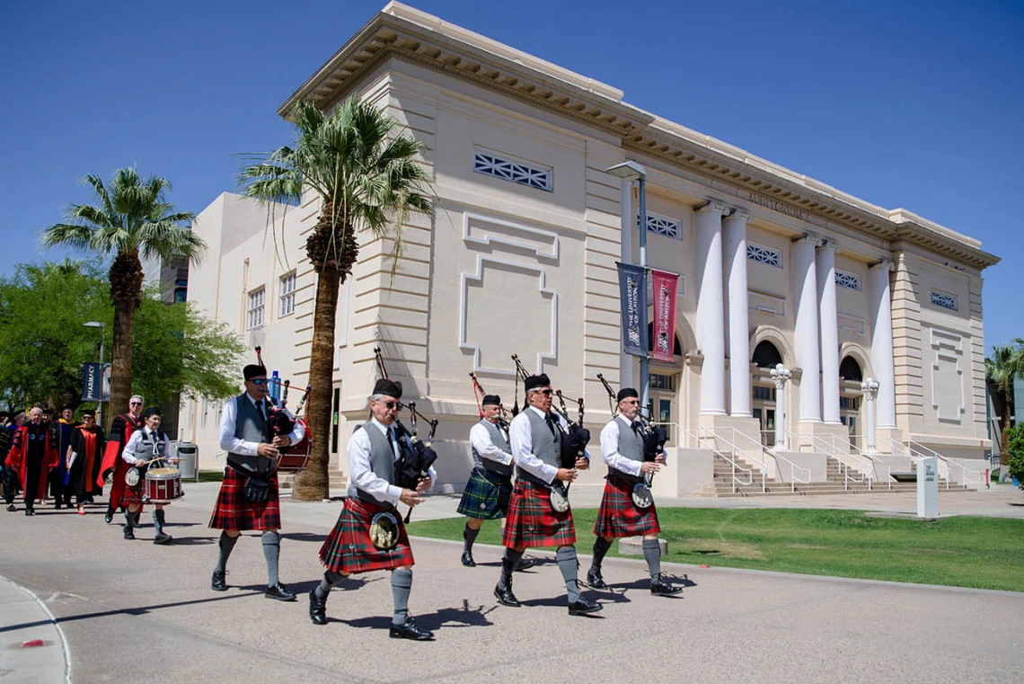 The College of Medicine – Phoenix class of 2022 is led by a pipe and drum corps through the streets of downtown Phoenix to their commencement ceremony at the Phoenix Convention Center.