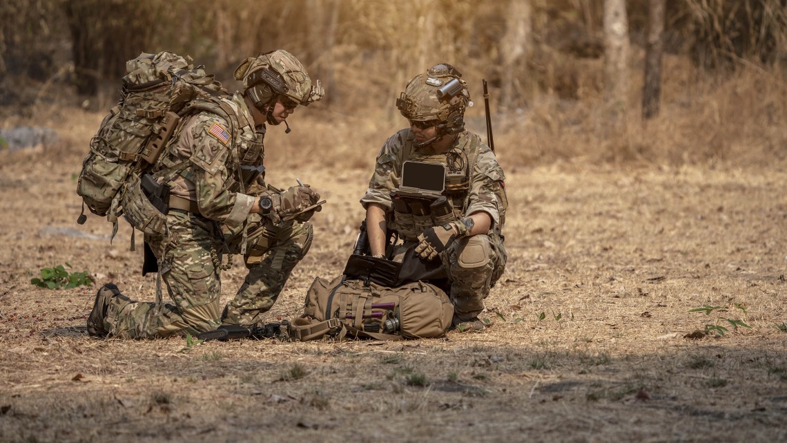 Soldiers crouching down and communicating