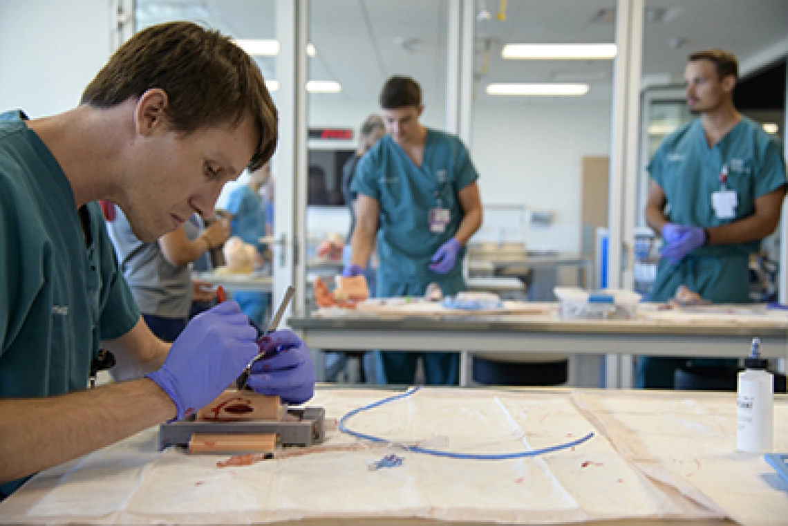 From left: Allan Hamilton, MD, executive director of ASTEC, Kevin Moynahan, MD, College of Medicine – Tucson deputy dean for education, and Deana Ann Smith, BS, BSN, RN, healthcare simulation educator, work on a life-size virtual dissection table. 