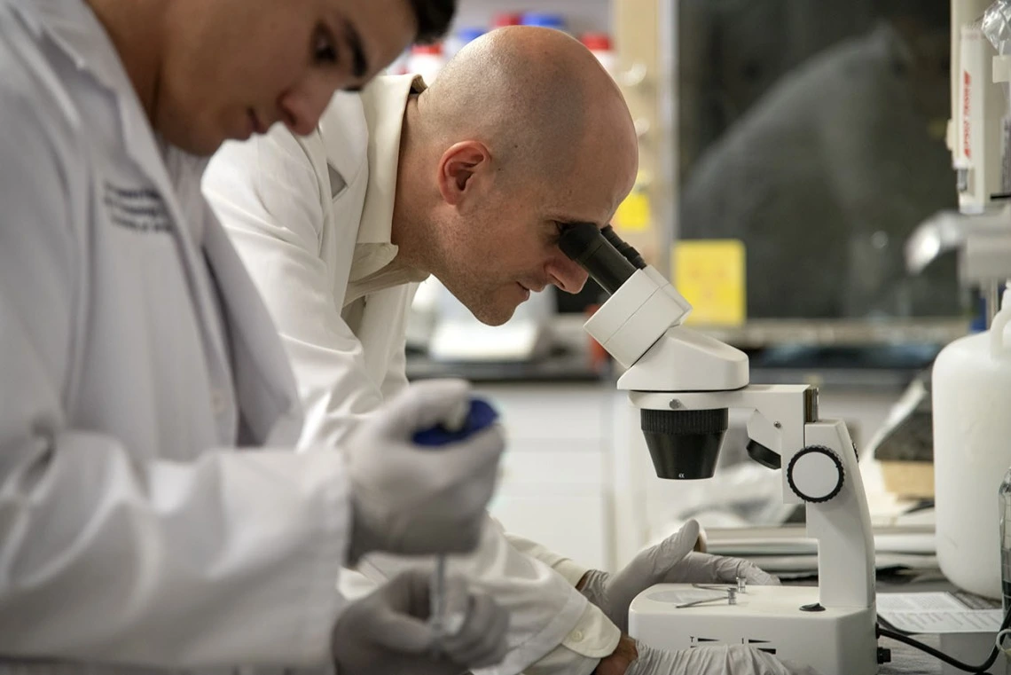 researcher with microscope
