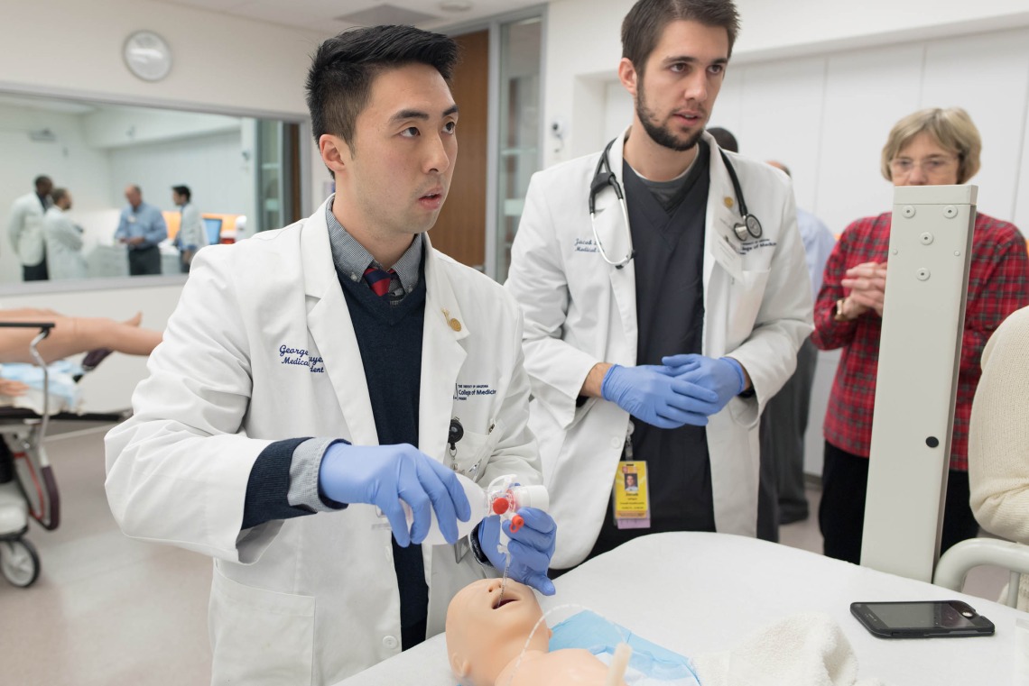 Two medical students training on a mannikin in a medical simulation center at the College of Medicine – Phoenix