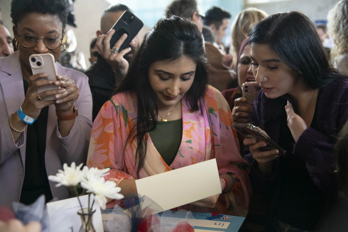 Two women read a sheet of paper at the University of Arizona College of Medicine – Phoenix Match Day celebration.