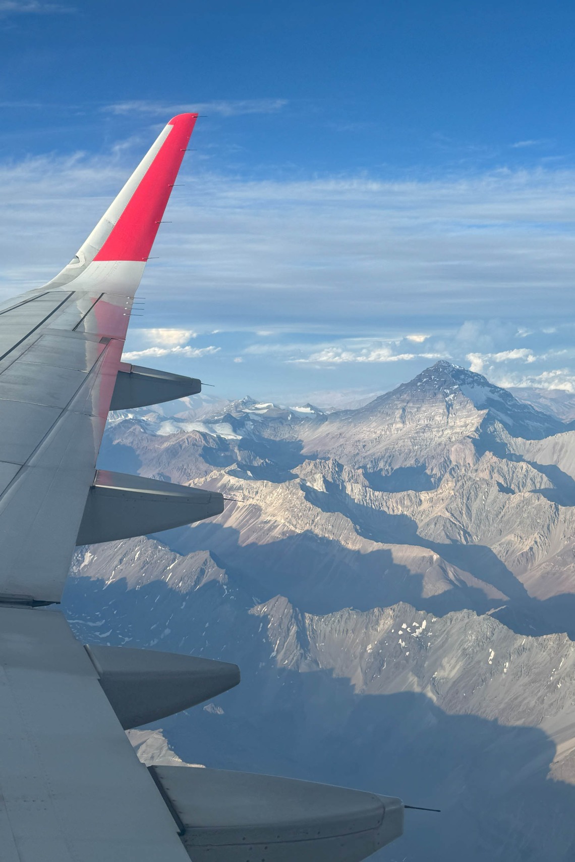 View of a plane’s wing with Aconcagua in the background. 