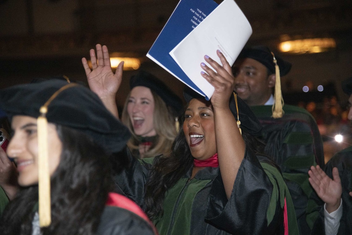 Several University of Arizona College of Medicine – Phoenix students cheer as university President Robert C. Robbins confers their degrees. 