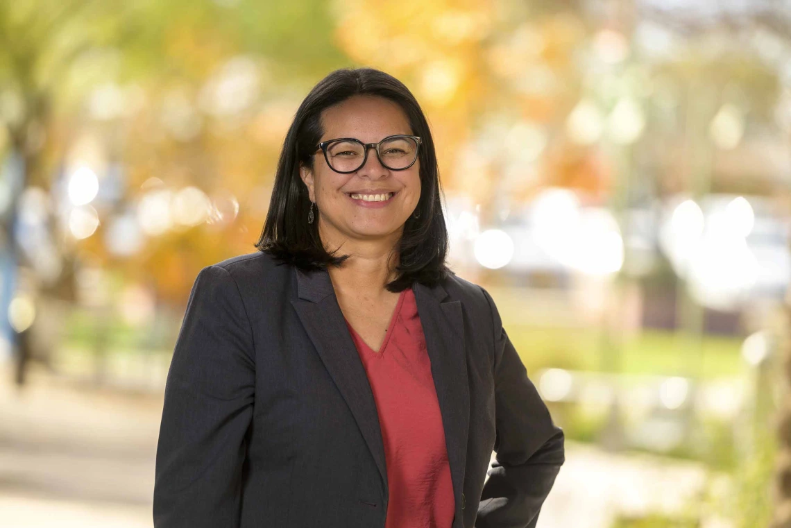 Portrait of Gabriela Valdez, PhD, standing outside. 