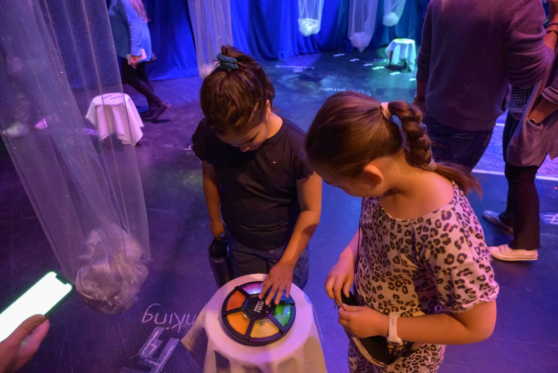 Two children play a light up memory game