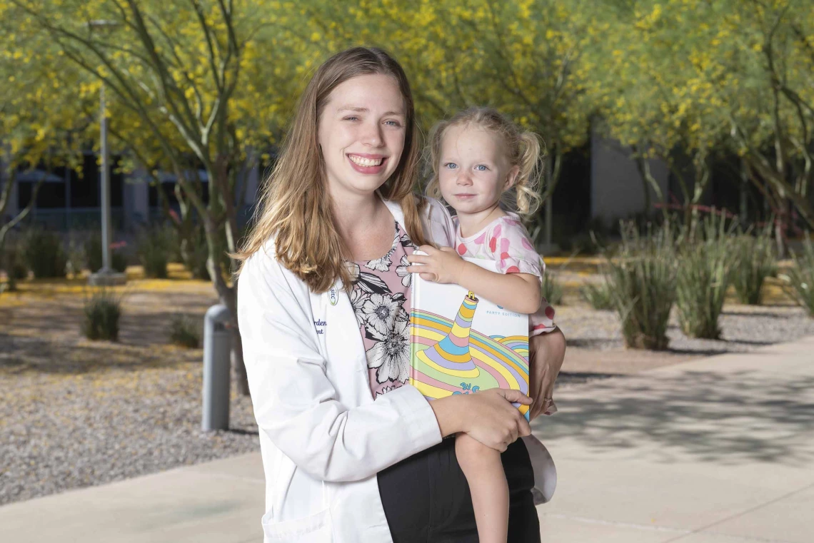 Elizabeth Borden, PhD, holding her 3-year-old daughter, Miriam