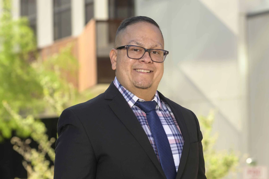 Portrait of Alejandro Vazquez, PharmD, standing outside smiling. 
