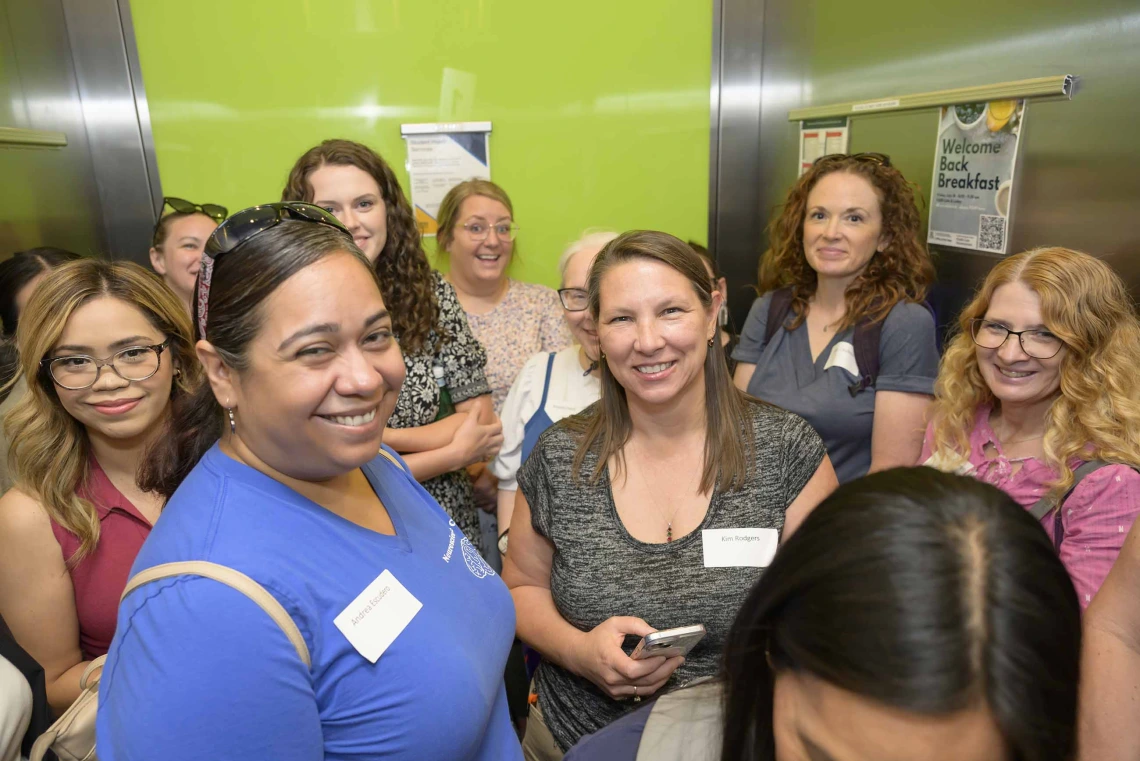 A group of educators crowds into an elevator at the Phoenix Bioscience Core. 