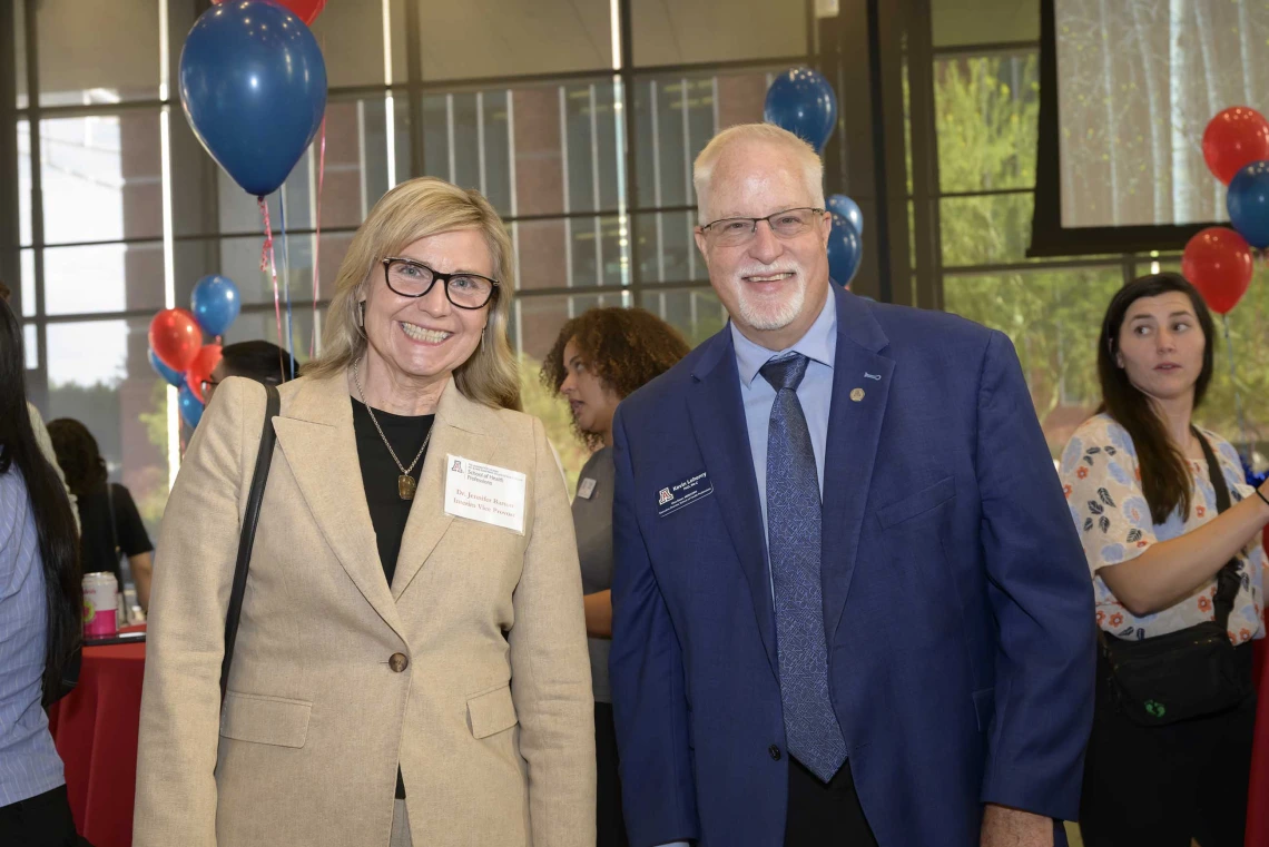 Photo of Jennifer Barton, PhD, interim vice provost for health programs, stands next to Kevin Lohenry, PhD, PA-C, vice dean of Health Professions Affairs and executive director of the School of Health Professions.