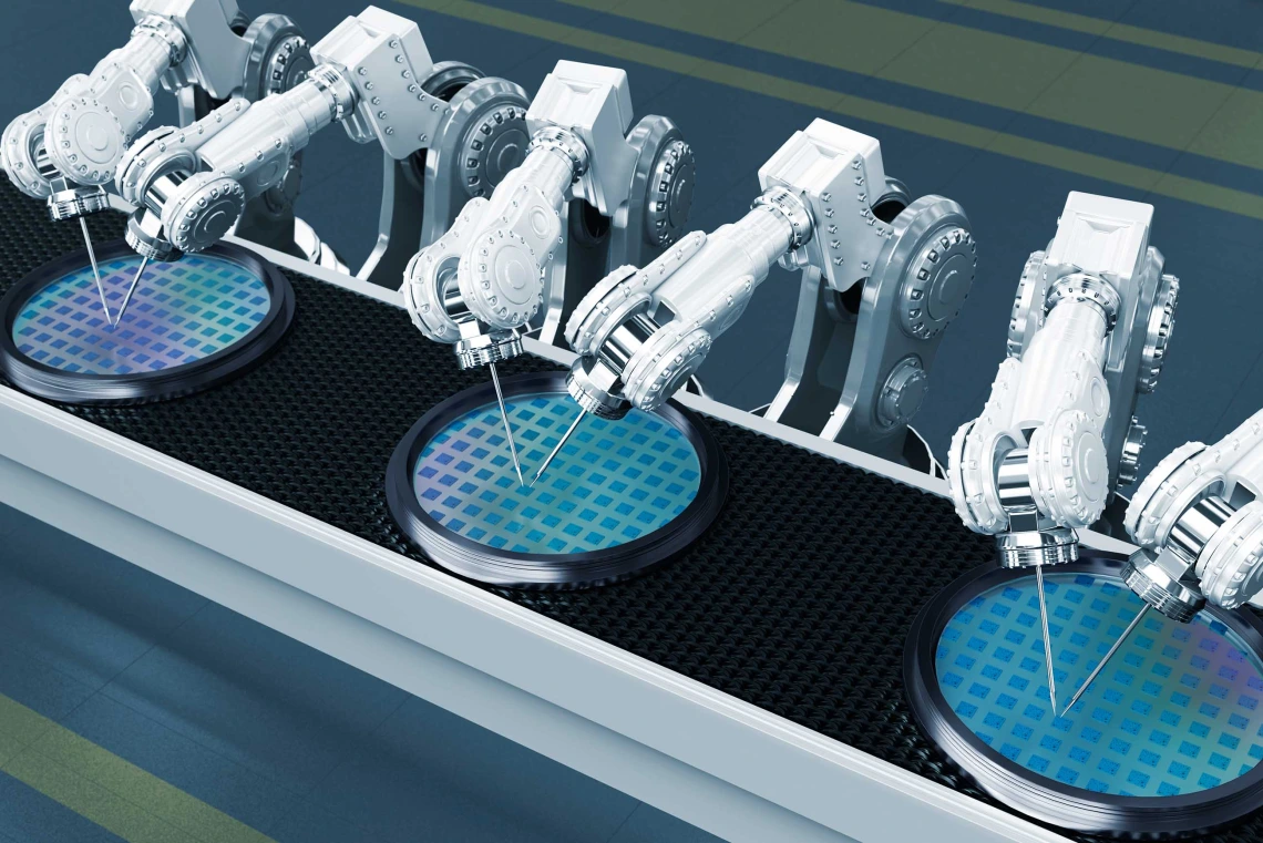 Six white robot arms working on blue circles on a semiconductor manufacturing line