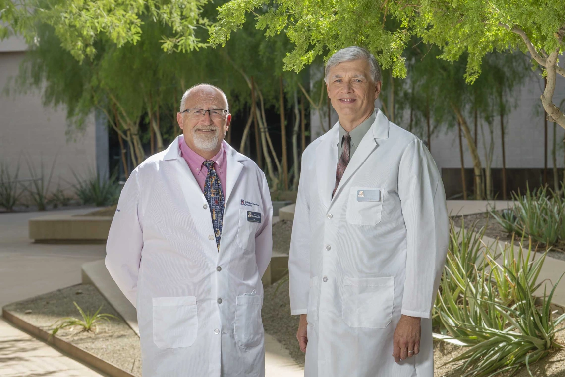 Photo of Stewart Goldman, MD, standing next to Vlad Kalinichenko, MD, PhD. Both are wearing white doctors coats.