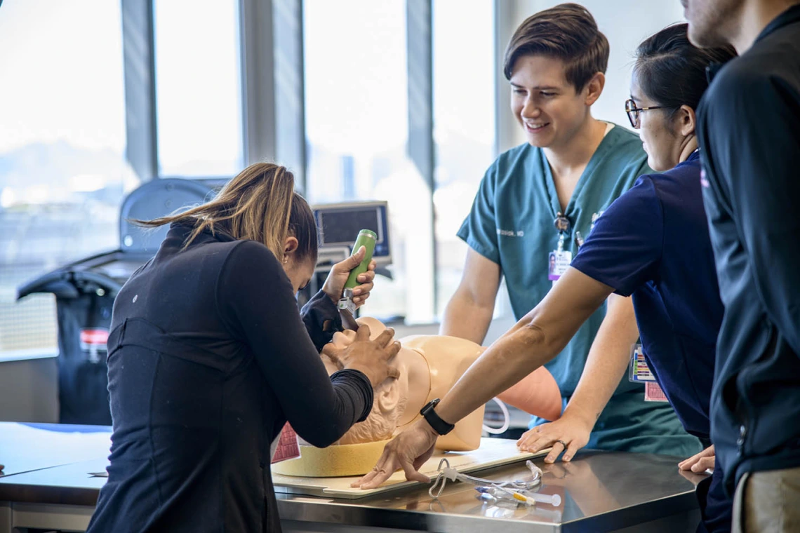 A medical student practices on a simulated airway.