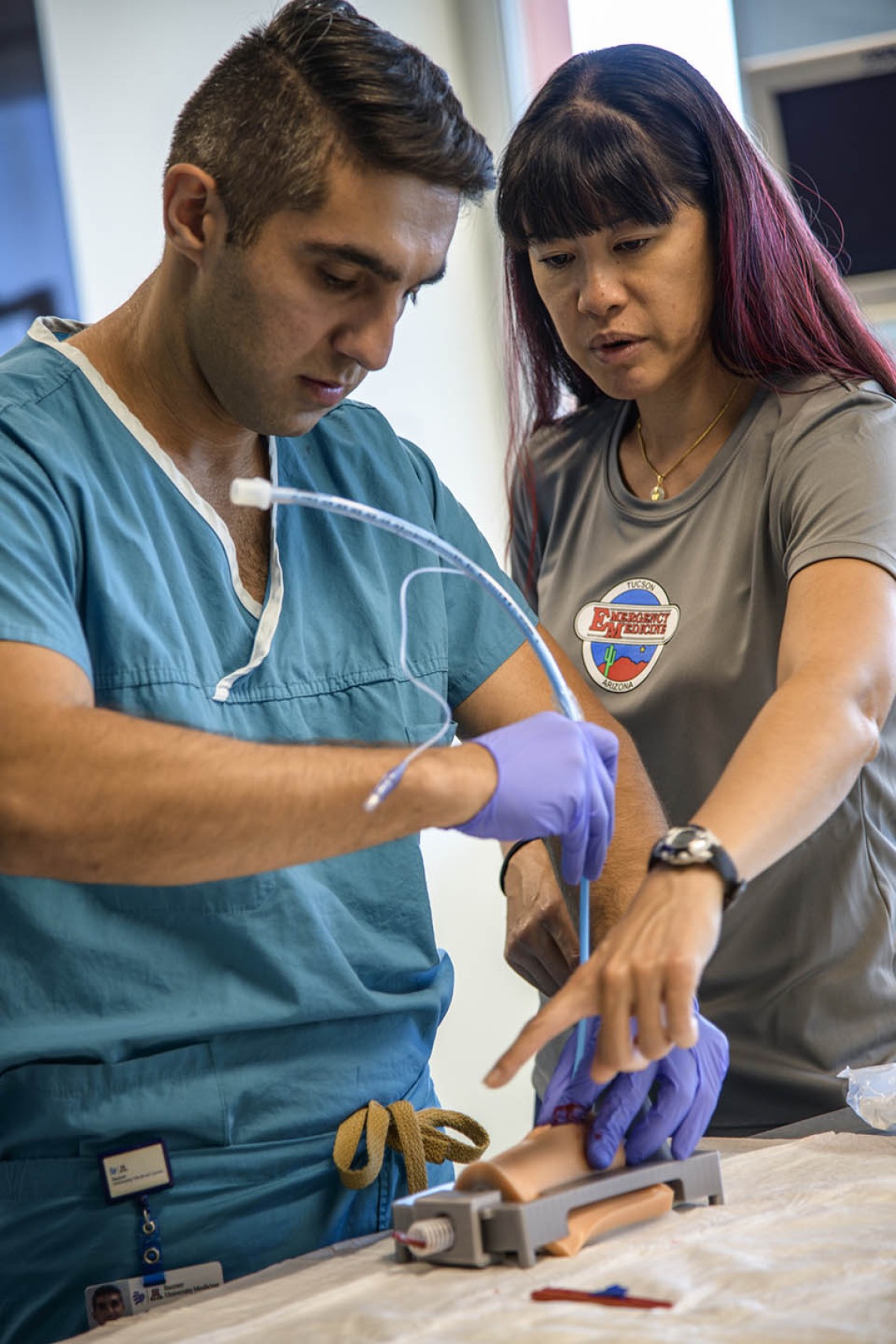 An emergency medicine student practices placing a tracheostomy tube using a simulated airway.