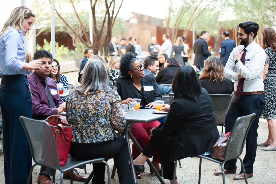 Attendees of the All of Us UArizona-Banner VIP reception at the Phoenix Bioscience Core campus network in the Grand Canyon courtyard during a beautiful spring evening. 