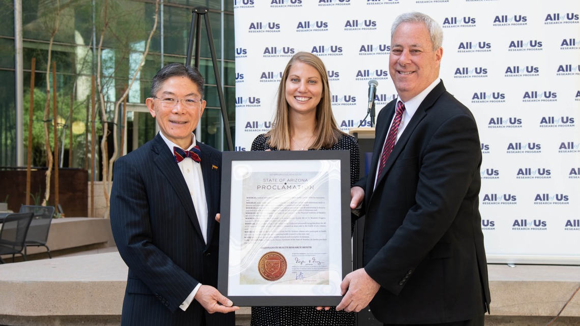(From left) Barry Wong, JD, director of the Governor’s Office of Equal Opportunity, presents the governor’s proclamation declaring March “Arizonans in Health Research Month” to Jennifer Craig-Muller, director of All of Us UArizona-Banner, and Eric Reiman, MD, chief executive director of Banner Research and principal investigator for All of Us UArizona-Banner.