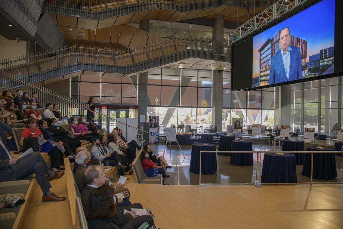 Attendees of the 50k Strong Arizona Celebration and Research Showcase watch the 50K Strong Arizona video at the beginning of the event held in the Health Sciences Innovation Building on the Tucson Campus. 
