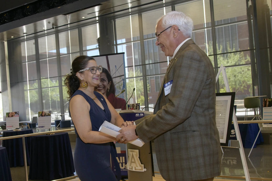 Lydia Aranda, president, Southern Arizona/Border Communities at Chicanos Por La Causa, greets Francisco Moreno, MD, associate vice president for UArizona Health Sciences Equity, Diversity and Inclusion, at the 50k Strong Arizona Celebration and Research Showcase in the Health Sciences Innovation Building on the Tucson campus.