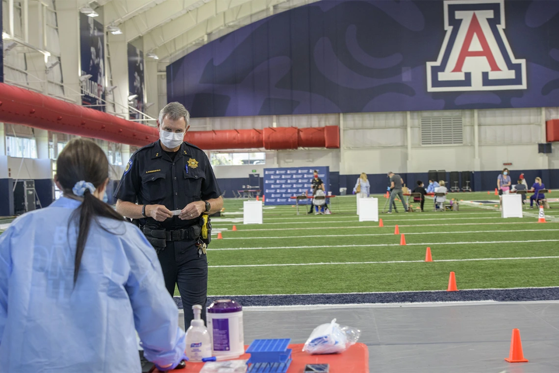 A Tucson-area police officer waits to be called to give a blood sample for the antibody test. 