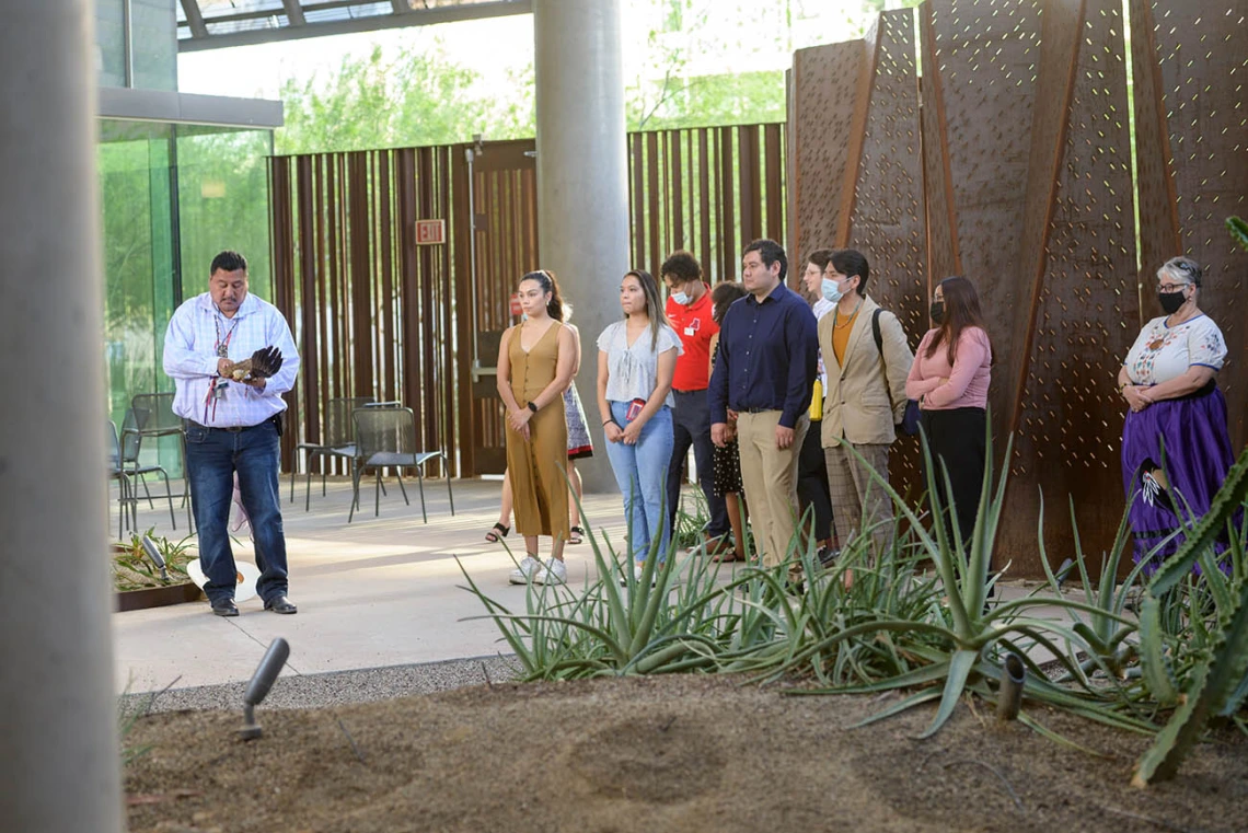 Participants gather before the start of the blessing ceremony in the Grand Canyon area at the Phoenix Bioscience Core as Miguel Flores Jr. (left) prepares to lead the ceremony. 