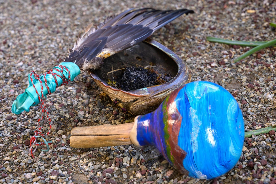 The ceremonial items used by Miguel Flores Jr., a Native American traditional healer, during the blessing ceremony at the College of Medicine – Phoenix include an eagle feather wand, blessing bowl and rattle.
