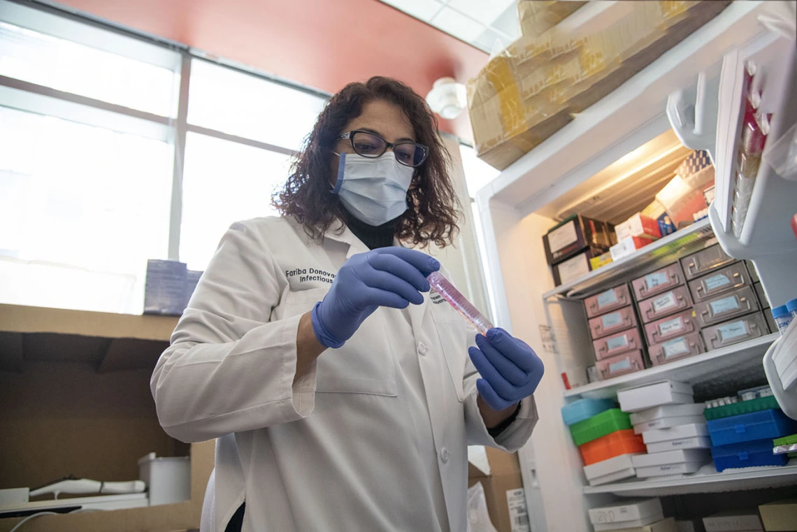 Researcher taking a sample out of the fridge