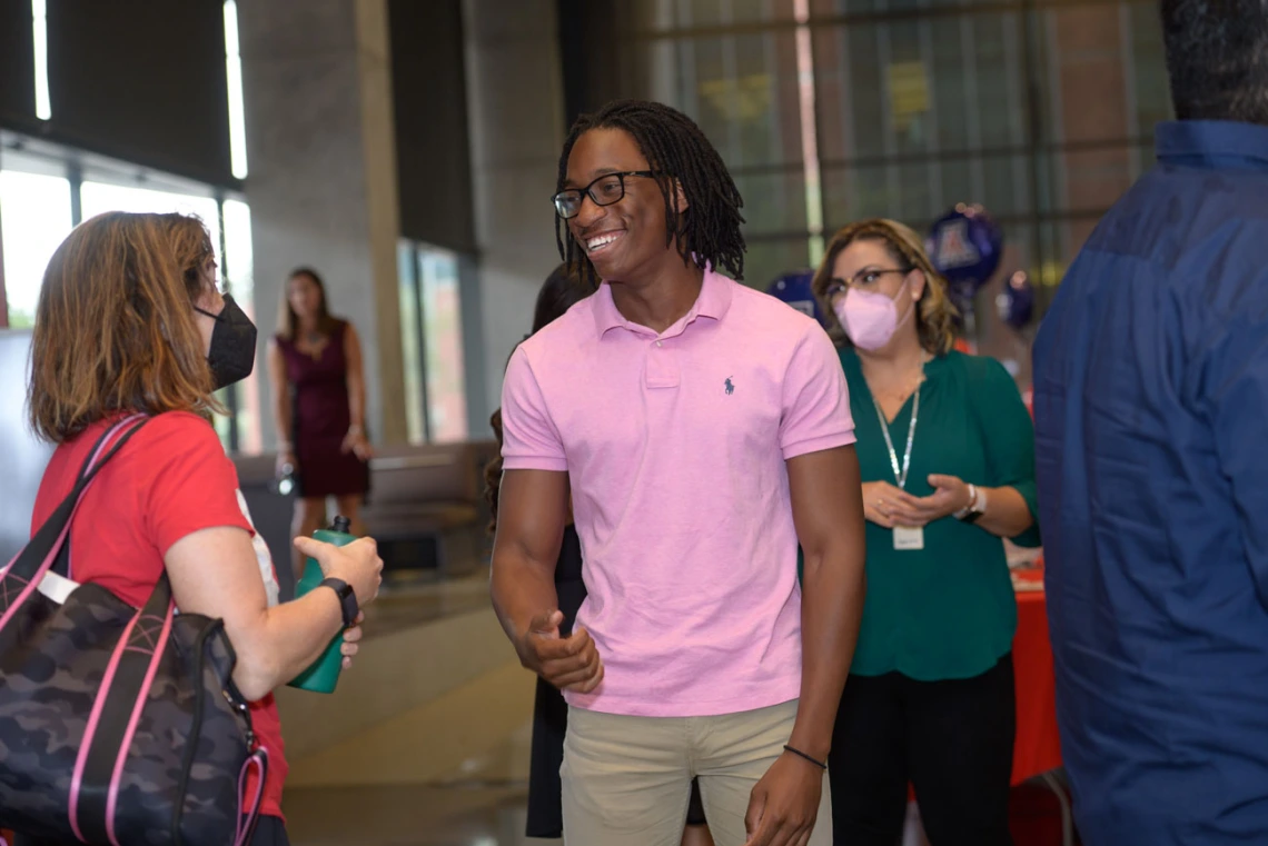 Zvavamwe takes a moment to catch up with staff and students at the closing ceremony of the FRONTERA/BLAISER program.