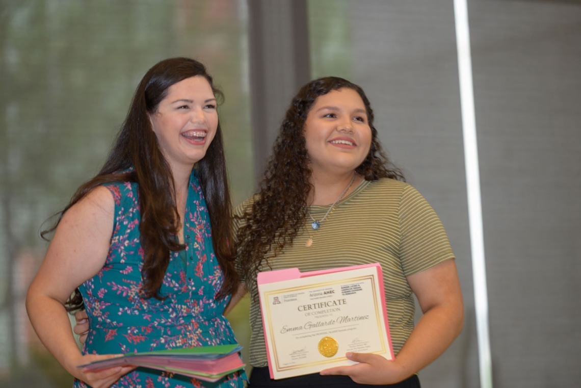FRONTERA/BLAISER program coordinator Genesis Garcia hands Martinez her certificate of completion at the closing ceremony in mid-August.