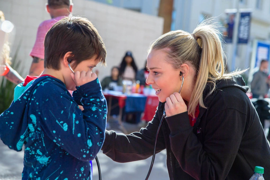 Pharmacy student listens to child's heartbeat; More than 9,000 kids attended 2020 Connect2STEM.