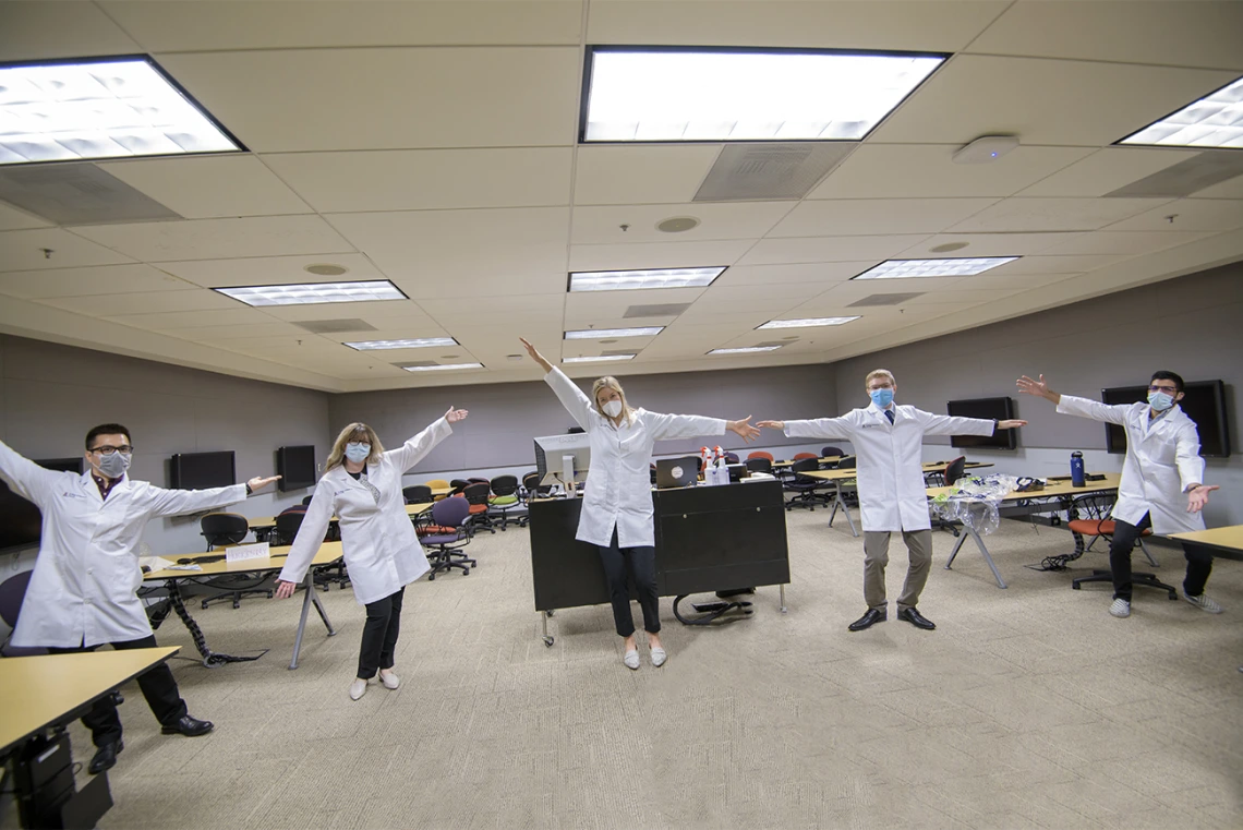 Members of Santa Rita House model face masks and white coats. From left: Daniel Nguyen, Bailey Antonowicz, April Huckleberry, Ethan Hill and Ahmed Al-Shamari.