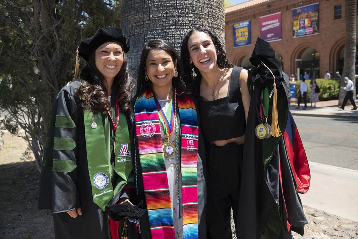Brianna Dolana, MD, Naiby Rodriguez Zuniga, MD, and Cara Sasha Popeski, MD, pause to take a photo before their College of Medicine – Tucson class of 2022 convocation at Centennial Hall.