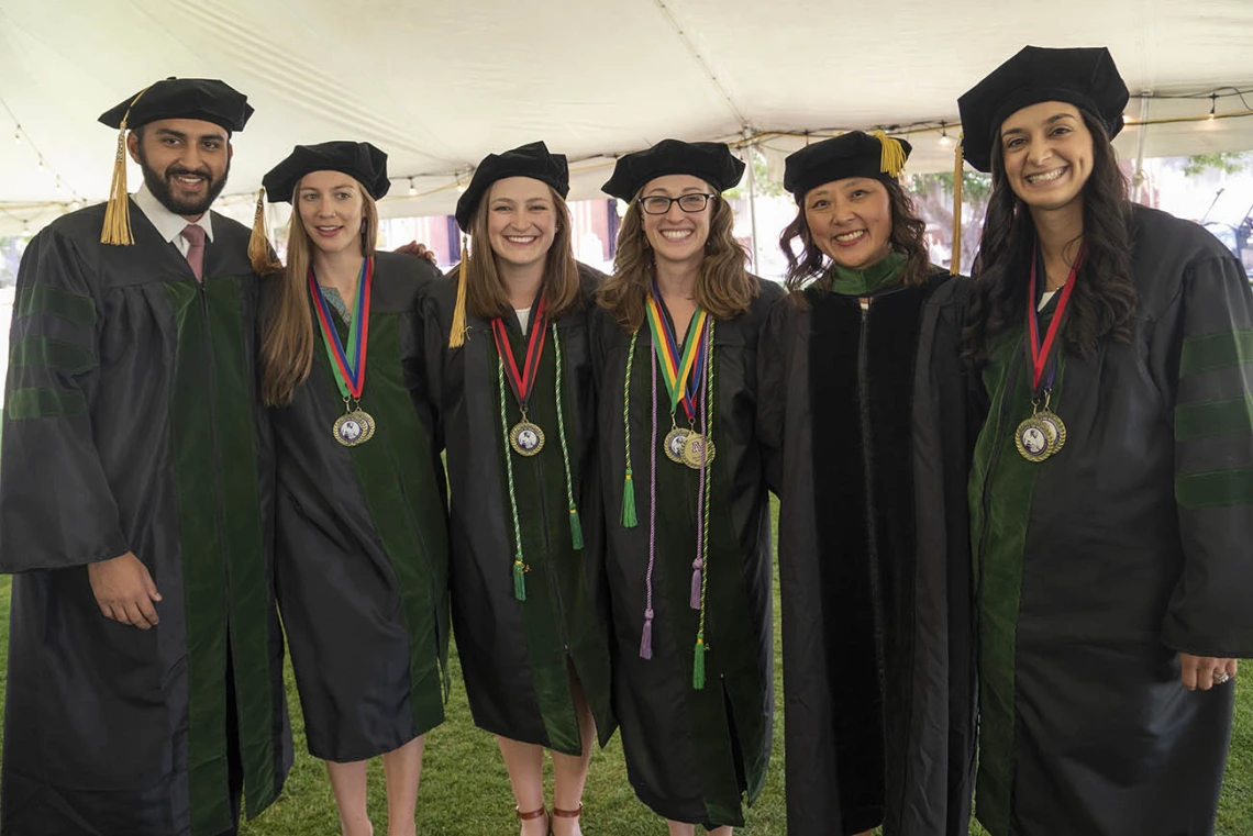 (From left) Abdullah Aleem, MD; Phoebe Bredin, MD; Abigail Slack, MD; Layne Jordan, MD; Allie Min, MD, assistant dean, career development; and Sara Ali Fermawi, MD, pose for a photo before the start of the College of Medicine – Tucson class of 2022 convocation at Centennial Hall.