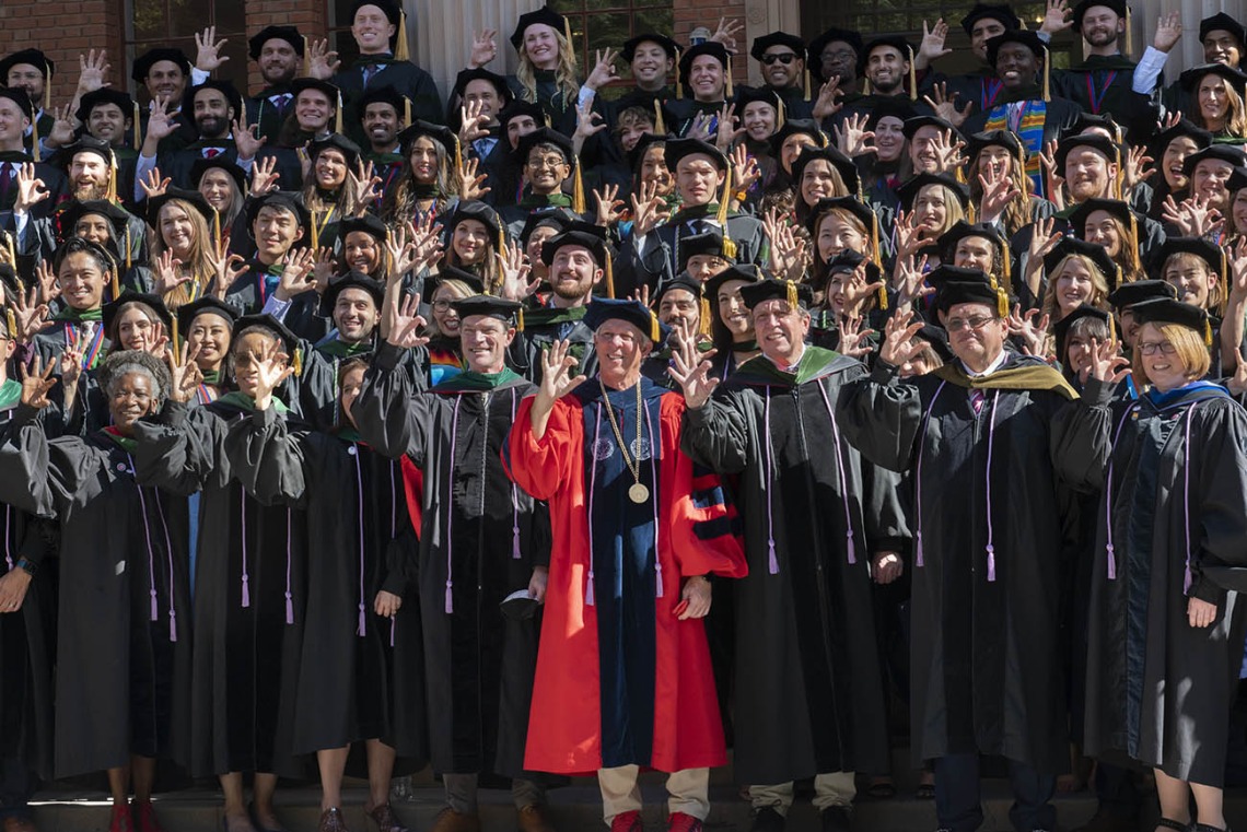 UArizona College of Medicine – Tucson graduates, faculty and staff give the Wildcat sign as they gather for a group photo after the class of 2022 convocation at Centennial Hall.