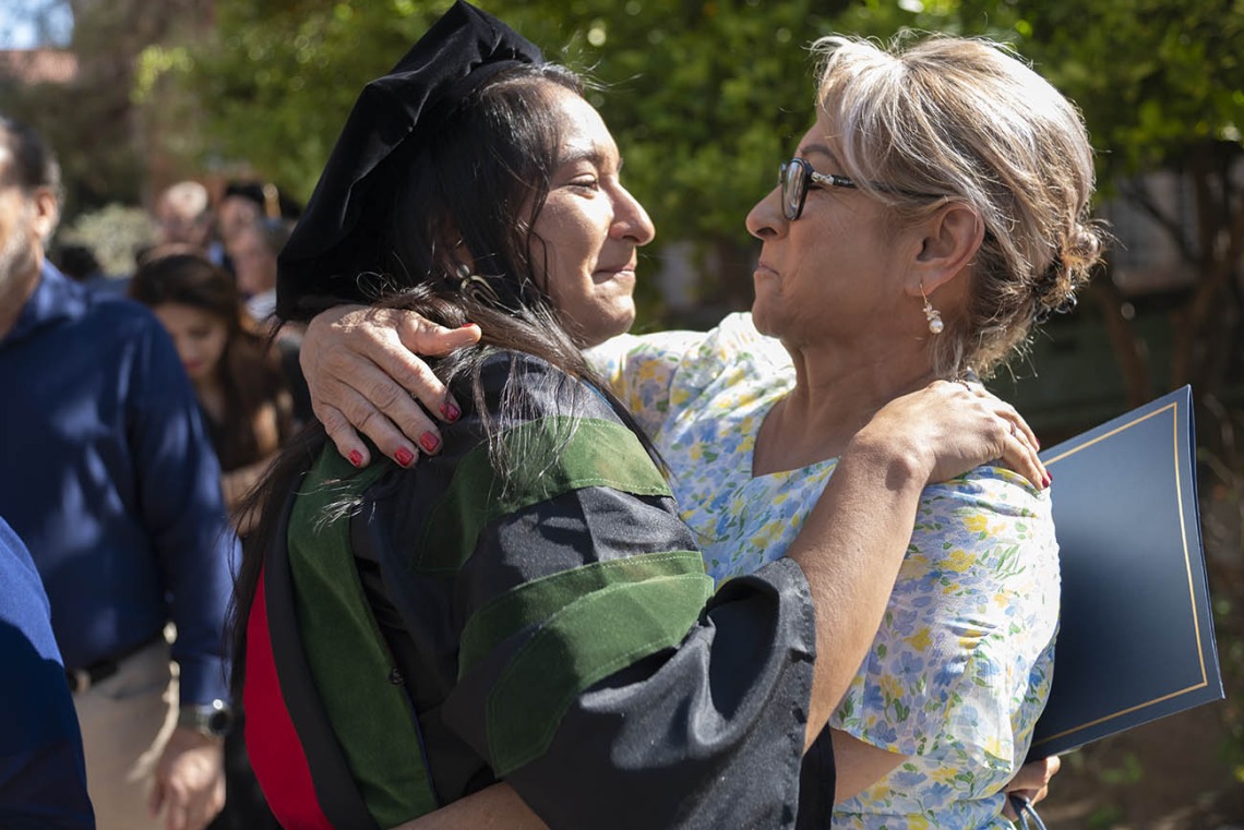 Naiby Rodriguez Zuniga, MD, hugs her mother after the College of Medicine – Tucson class of 2022 convocation at Centennial Hall.