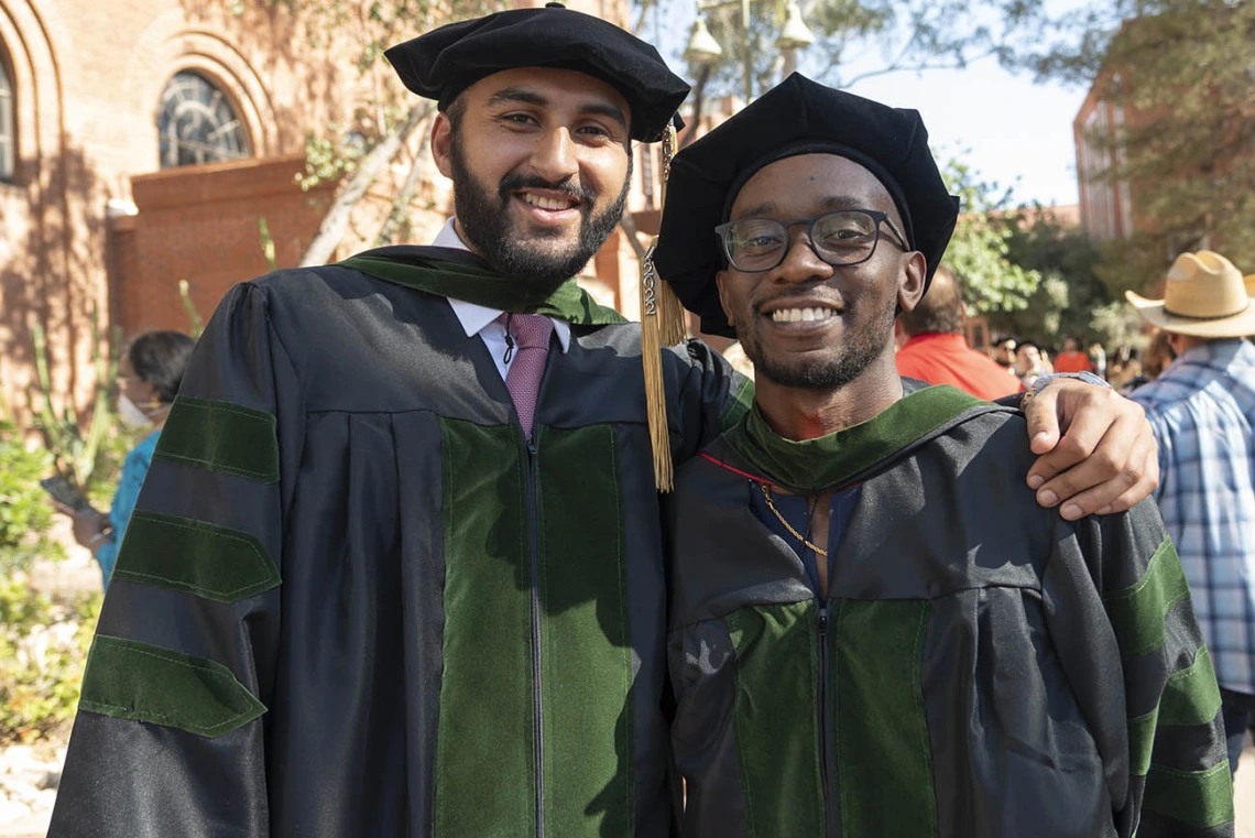 Abdullah Aleem Mian, MD, and Andrew Muse, MD, pose for a photo together after the College of Medicine – Tucson class of 2022 convocation at Centennial Hall.