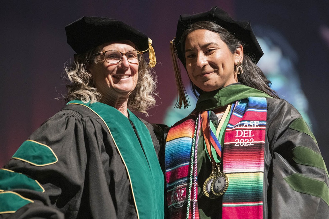 Professor Patricia Lebensohn, MD, poses for a photo with Naiby Rodriguez Zuniga, MD, after hooding her during the College of Medicine – Tucson class of 2022 convocation at Centennial Hall. 
