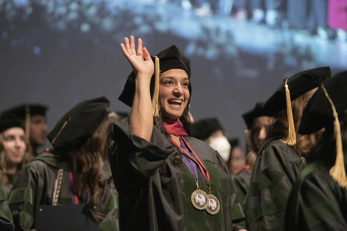 Sara Ali Fermawi, MD, waves out to the audience at the end of the College of Medicine – Tucson class of 2022 convocation ceremony at Centennial Hall.