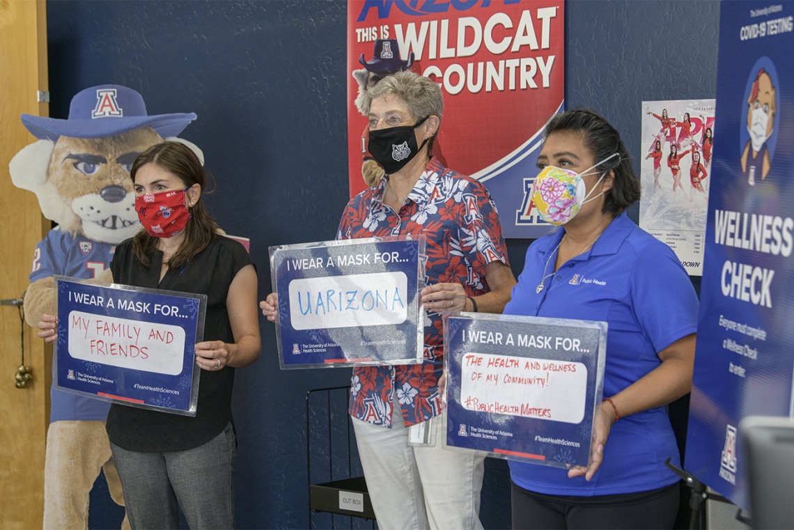 Faculty at the Mel and Enid Zuckerman College of Public Health on the Phoenix Biomedical Campus share their signs. From left: Leila Barraza, JD, MPH, associate professor, Janet Foote, PhD, assistant professor and Alma Ramirez, health educator.