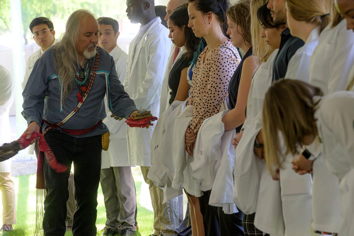 Carlos Gonzales, MD, blesses each participant in the Tree Blessing Ceremony with the smoke of the sacred herbs. Dr. Gonzales is the assistant dean of curricular affairs for the College of Medicine – Tucson. 
