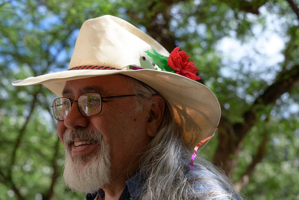 Carlos Gonzales, MD, watches as medical students plant a tree honoring those who donated their bodies to the Willed Body Program at the College of Medicine – Tucson.