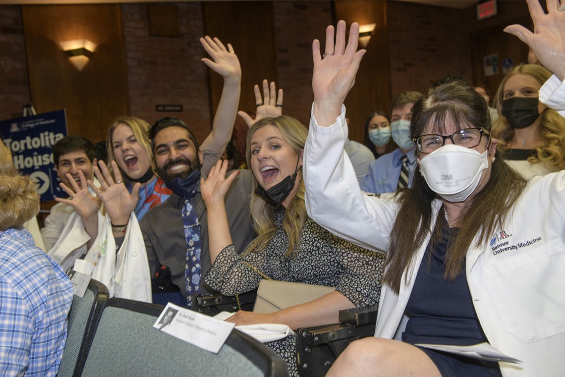 Members of the College of Medicine – Tucson Tortolita House show their excitement prior to the start of their twice-postponed white coat ceremony. 