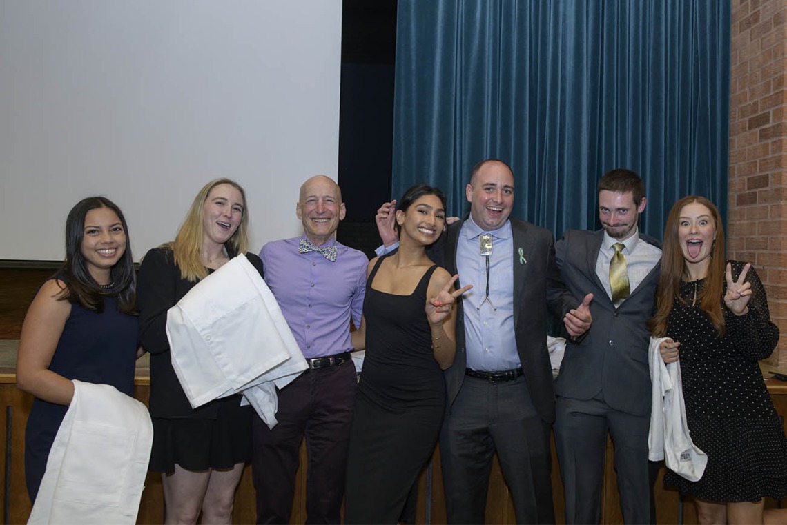 UArizona College of Medicine – Tucson students from the Santa Rita House have some fun with Paul Gordon, MD, MPH, during their twice-postponed white coat ceremony. From left are Samantha Nemivant, Kendra Coleman, Dr. Gordon, Meghana Partha, Daniel Sadoway, Colin Fields and Elly Hitt.