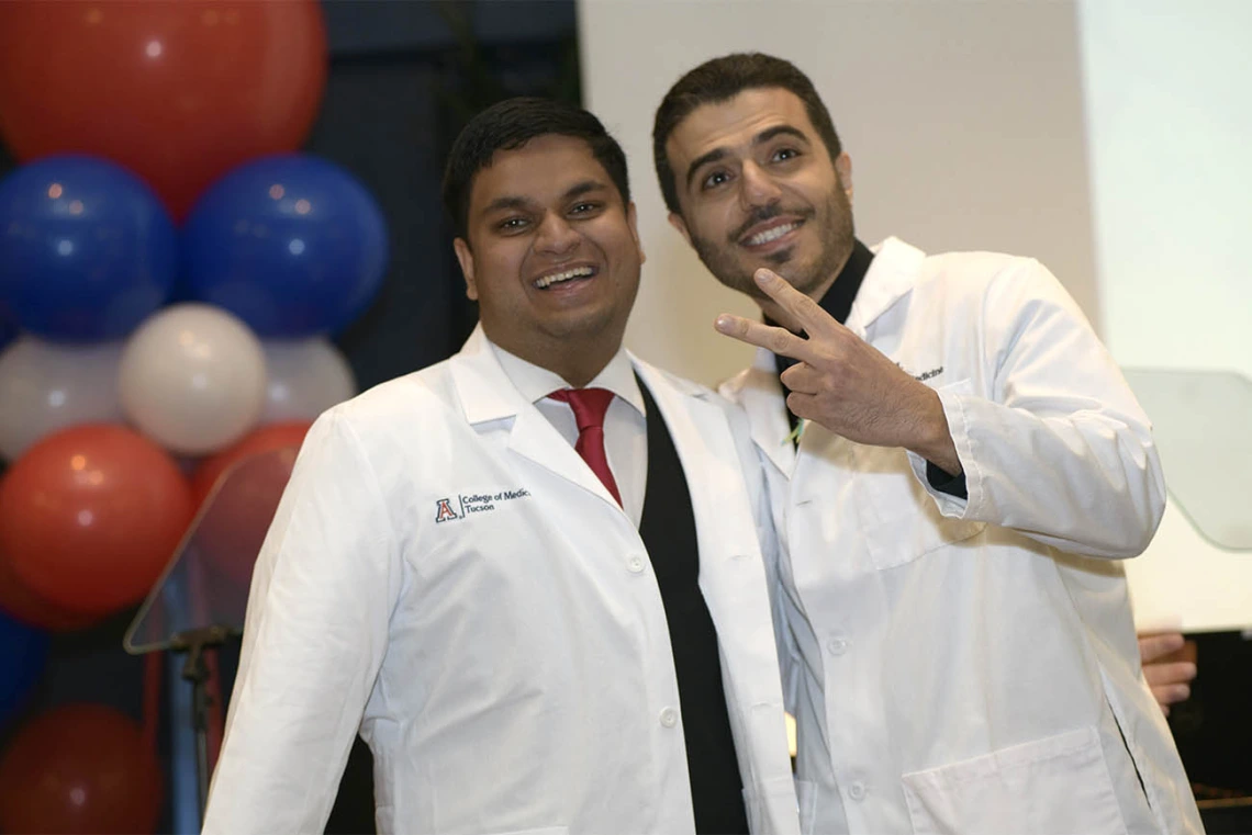 Abhimanyu Chadha (left) pauses for a photo after receiving his white coat from Ahmad Al-Khashman, MD, clinical assistant professor at the UArizona College of Medicine – Tucson.