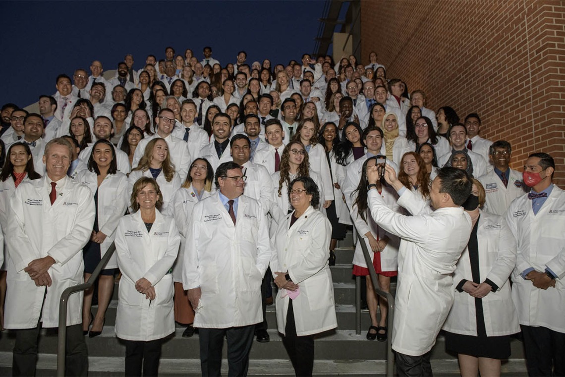 Keynote speaker, Bert B. Vargas, MD, (lower right) takes a picture of the UArizona College of Medicine – Tucson class of 2024 after their white coat ceremony. 