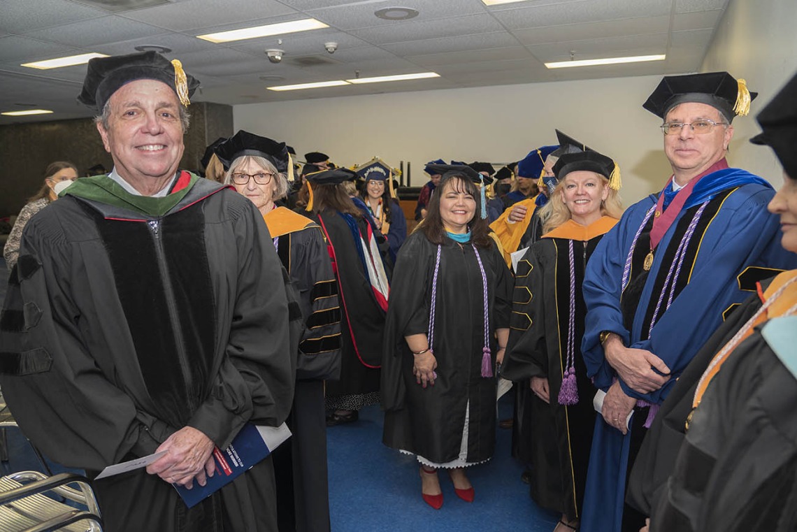 Senior Vice President for Health Sciences, Michael D. Dake, MD, (left) prepares to take the stage with UArizona College of Nursing faculty and staff before the start of their 2022 spring convocation at Centennial Hall.