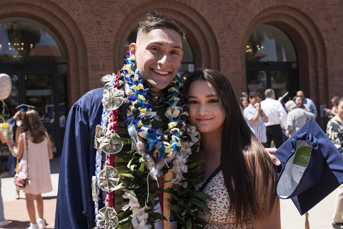 Alex Garcia Quezada poses for a photo with his girlfriend Elizabeth Walter after being awarded a Bachelor of Science in Nursing at the UArizona College of Nursing 2022 spring convocation at Centennial Hall.